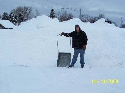 1989 Ford F-150 - A man stands with a snow shovel in front of massive snow drifts, with the date 01/10/2009 visible in the lower right corner.