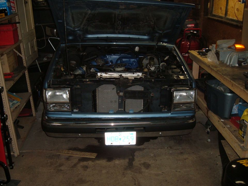 Front view of a 1990 Ford Ranger with hood open, showing the engine bay and radiator