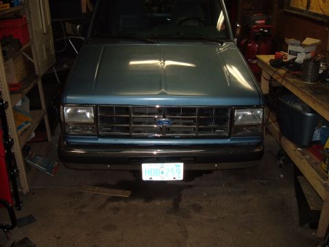 1990 Ford Ranger - Front view of a blue 1990 Ford Ranger pickup truck, its chrome grille and clear corner lights.
