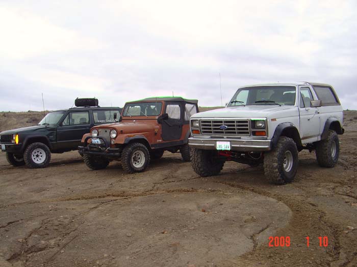 White 1983 Ford Bronco 3/4 front view with lifted suspension and off-road tires