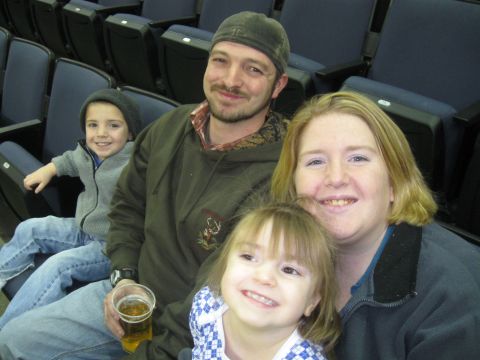 1994 Ford Bronco - A family enjoys a day out, posing for a photo in stadium seating.