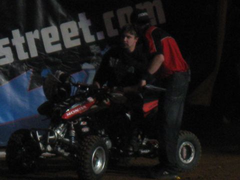 1994 Ford Bronco - Two people are with a Honda ATV. A banner with 'street.com' is visible in the background.