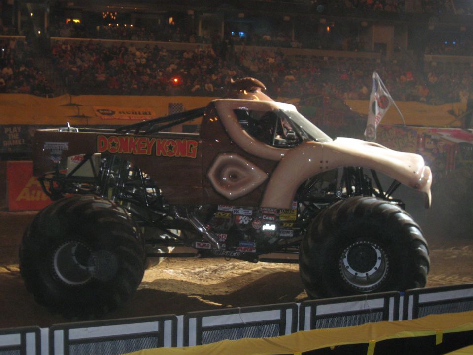 Brown Donkey Kong monster truck with large tires and a cartoonish ape-like front end, viewed from the side