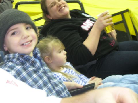 1994 Ford Bronco - A family enjoys an event together, with a child in the foreground and adults in the background.
