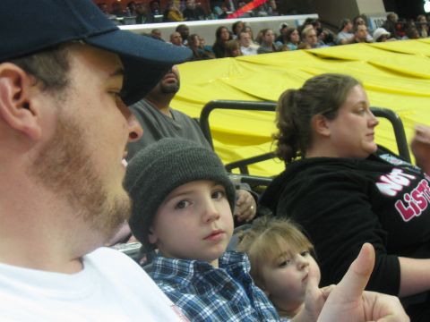 1994 Ford Bronco - Spectators watch an event from stadium seating with a yellow tarp in the background.