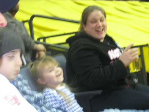 1994 Ford Bronco - Spectators watch an event from stadium seating with a bright yellow background.