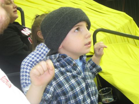 1994 Ford Bronco - A child watches something above, seated in an area with bright yellow fabric and black railings.