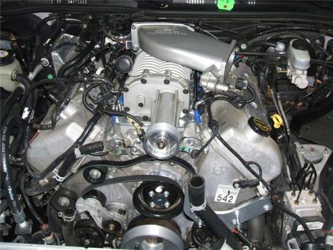 1996 Ford Thunderbird - Close-up view of a supercharged engine bay, showing various components and a visible part number.