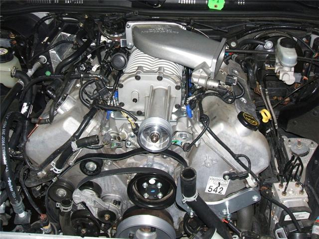 Engine bay with supercharger and visible part number 542