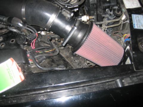 1996 Ford Thunderbird - Close-up view of a vehicle's engine compartment, focusing on the air intake system.