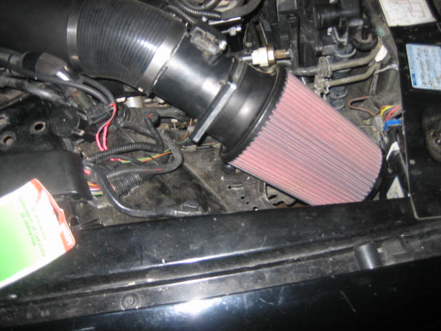 engine bay with aftermarket air filter and intake tube