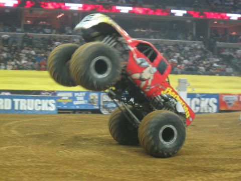 1994 Ford Bronco - A monster truck named 'Barbarian' lifts its front wheels off the ground during a performance.
