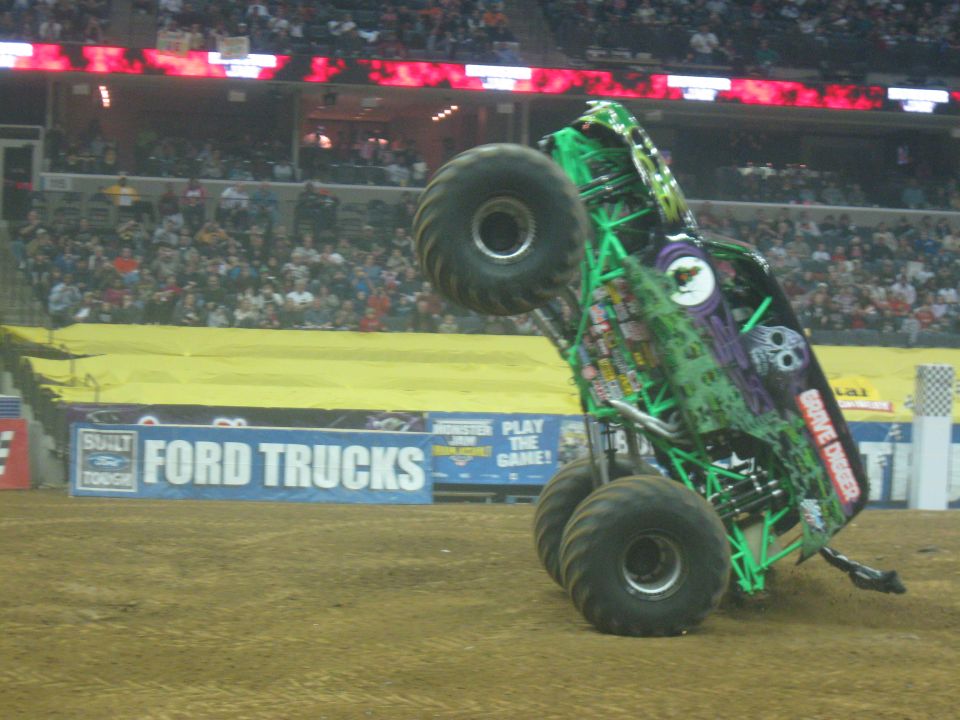 Monster truck performing a wheelie, with 'Grave Digger' visible on its side