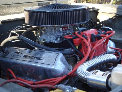 1971 Ford Bronco - Close-up of engine components including a Ford Racing valve cover and Edelbrock carburetor.