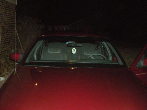 1994 Ford Crown Victoria - Front view of a red 1994 Ford Crown Victoria at night, showing the interior and hood.