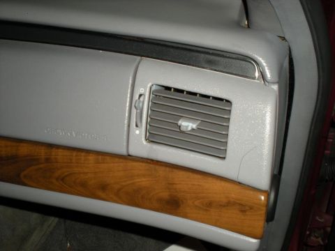 1994 Ford Crown Victoria - Interior view of a 1994 Ford Crown Victoria, showing the dashboard vent and wood grain trim.