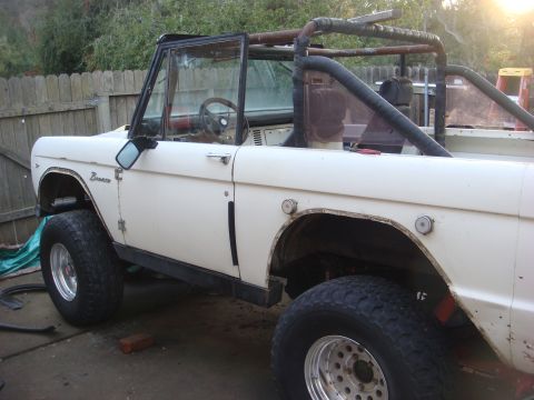 1968 Ford Mustang - This 1968 Ford Bronco is shown with its doors open and a roll cage installed, suggesting it may be undergoing restoration or modification.