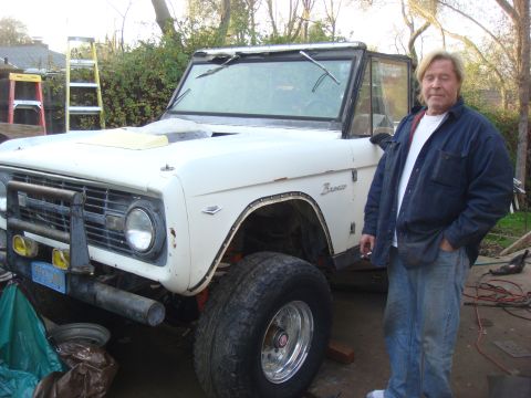 1968 Ford Mustang - A man poses with a white first-generation Ford Bronco, likely undergoing restoration or modification.
