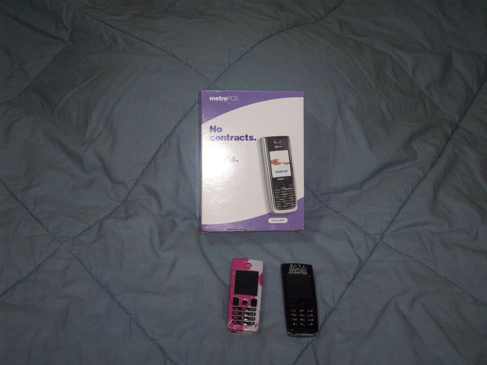 Three cell phones and a MetroPCS box with 'No contracts.' text