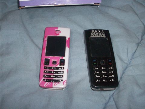 2006 Ford F-150 - Two cell phones, one decorated with hearts and the other with flames, lie on a blue blanket.