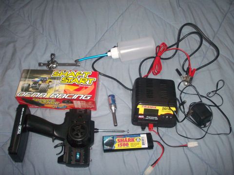 2006 Ford F-150 - RC car starter box, charger, battery, and remote control are laid out on a blue blanket.