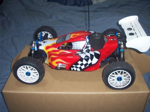 2006 Ford F-150 - This remote control buggy features a vibrant red body with flame graphics and a checkered flag design.