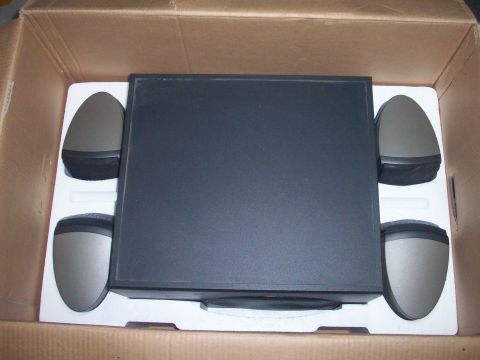 2006 Ford F-150 - A set of computer speakers and a subwoofer are packed in a cardboard box with protective foam inserts.