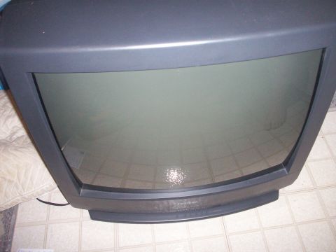 2006 Ford F-150 - A CRT television is shown from a top-down perspective, resting on a tiled floor.