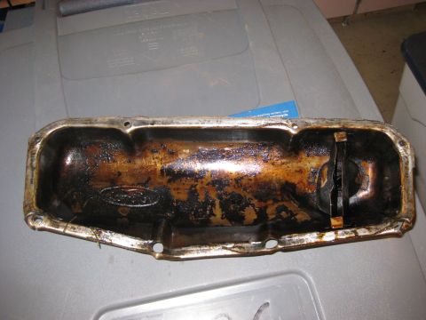 1979 Ford Bronco - This is a Ford oil pan, showing significant buildup of old oil and residue.