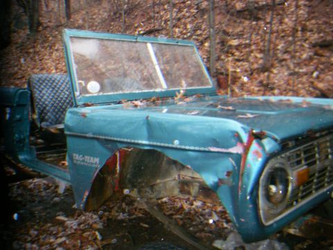 1978 Ford Bronco - This teal Bronco body shows significant front-end damage and is missing its hood and fenders.