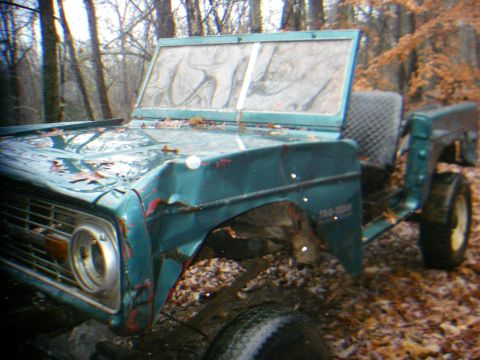 1978 Ford Bronco - This 1978 Ford Bronco body sits in a wooded area, showing signs of age and disrepair.