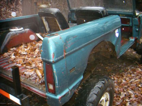 1978 Ford Bronco - 1978 Ford Bronco showing its rear quarter panel and interior. The vehicle appears to be in a state of disrepair or disassembly.