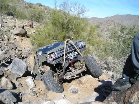 1986 Toyota Hilux - This heavily modified off-road truck is navigating a difficult rocky trail.