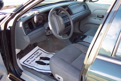 2001 Ford Crown Victoria - Interior view of a 2001 Ford Crown Victoria, showing the driver's seat, dashboard, and floor mat.