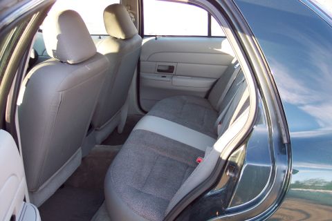 2001 Ford Crown Victoria - Interior view of the back seat area of a sedan, showing the seats and door trim.