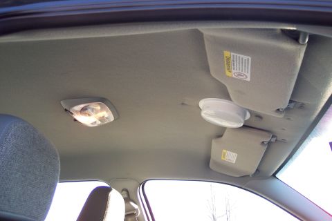 2001 Ford Crown Victoria - Interior view of a car's ceiling, showing sun visors and a dome light.