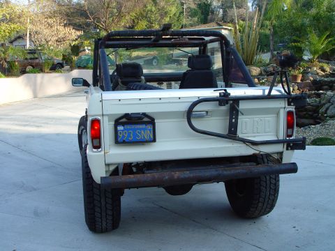 1968 Ford Mustang - Rear view of a white 1968 Ford Bronco with a spare tire carrier mounted on the tailgate.