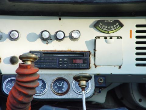 1968 Ford Mustang - The interior dashboard shows a collection of gauges and an aftermarket stereo system.