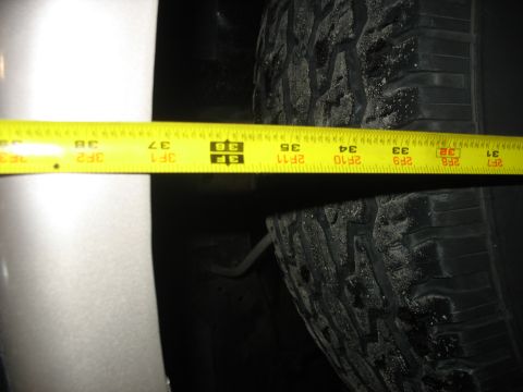 1995 Ford C-350 (Centurion Conversions) - Measuring tire clearance with a tape measure. The tape shows measurements from 33 to 38 inches.
