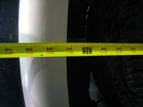 1995 Ford C-350 (Centurion Conversions) - A tape measure is used to check the clearance next to a vehicle's tire.