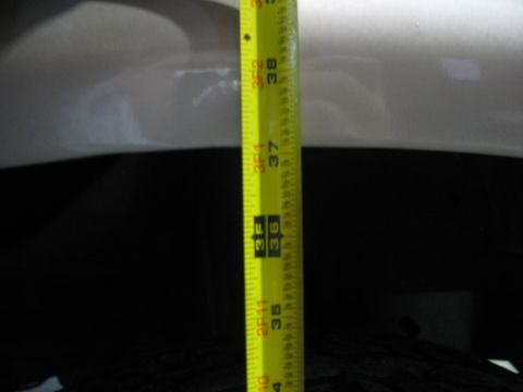 1995 Ford C-350 (Centurion Conversions) - A measuring tape is held against the side of a vehicle, indicating a height measurement of approximately 36.5 inches.