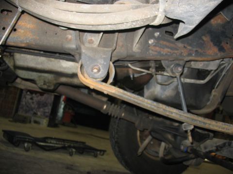 1995 Ford C-350 (Centurion Conversions) - Close-up of truck's undercarriage, focusing on the leaf spring and suspension system.