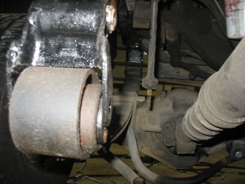 1995 Ford C-350 (Centurion Conversions) - A close-up view of a worn suspension bushing and linkage, likely from a heavy-duty truck.