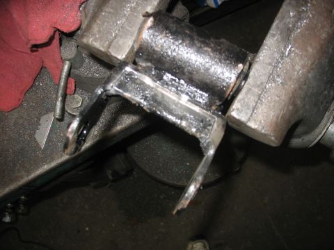 1995 Ford C-350 (Centurion Conversions) - A metal part is secured in a vise, possibly for repair or modification.