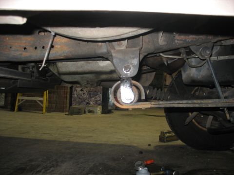1995 Ford C-350 (Centurion Conversions) - This image shows a close-up view of a vehicle's undercarriage, focusing on a suspension component.