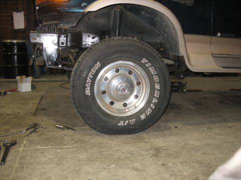 1995 Ford C-350 (Centurion Conversions) - Truck front wheel and suspension components are visible with the bumper removed.