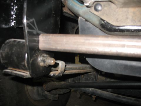 1995 Ford C-350 (Centurion Conversions) - Underside view of a vehicle's suspension system, focusing on the leaf spring and related hardware.