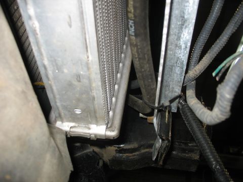 1995 Ford C-350 (Centurion Conversions) - Close-up view of a radiator and hoses, with visible wiring and metal brackets.