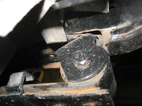 1995 Ford C-350 (Centurion Conversions) - A detailed view of a vehicle's suspension system, focusing on a specific component and surrounding frame elements.