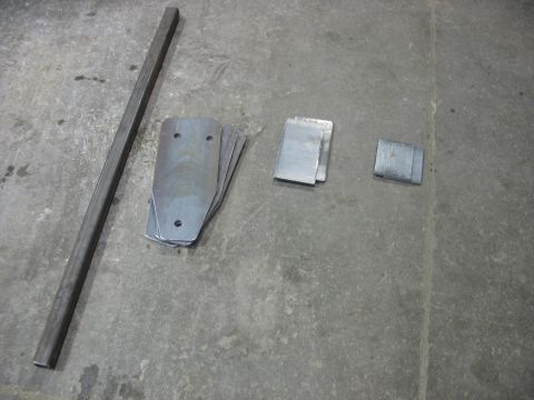 1995 Ford C-350 (Centurion Conversions) - Various metal components laid out on a concrete surface.